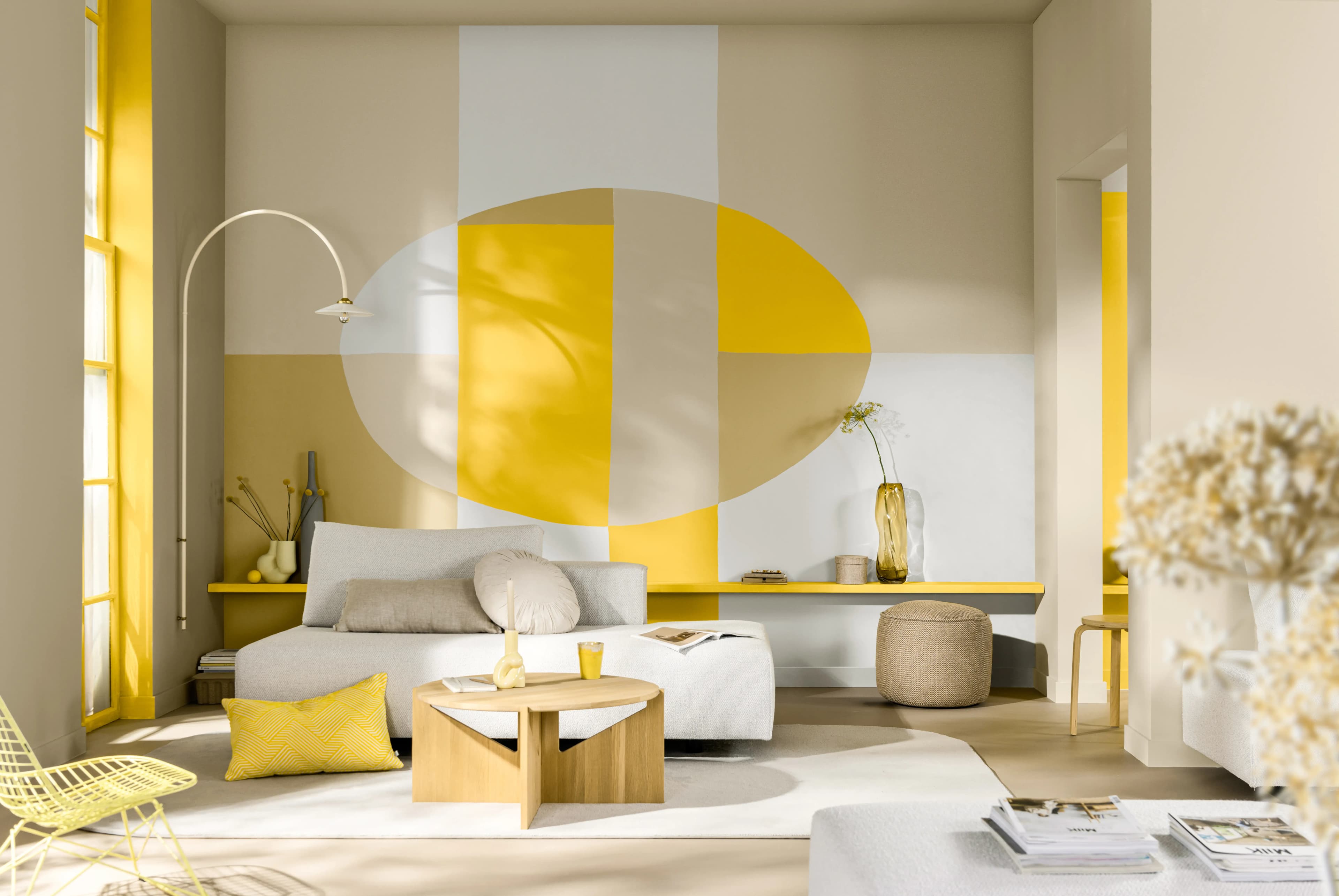 Living room with walls painted with a free-form shape, cut into sections of different colours.