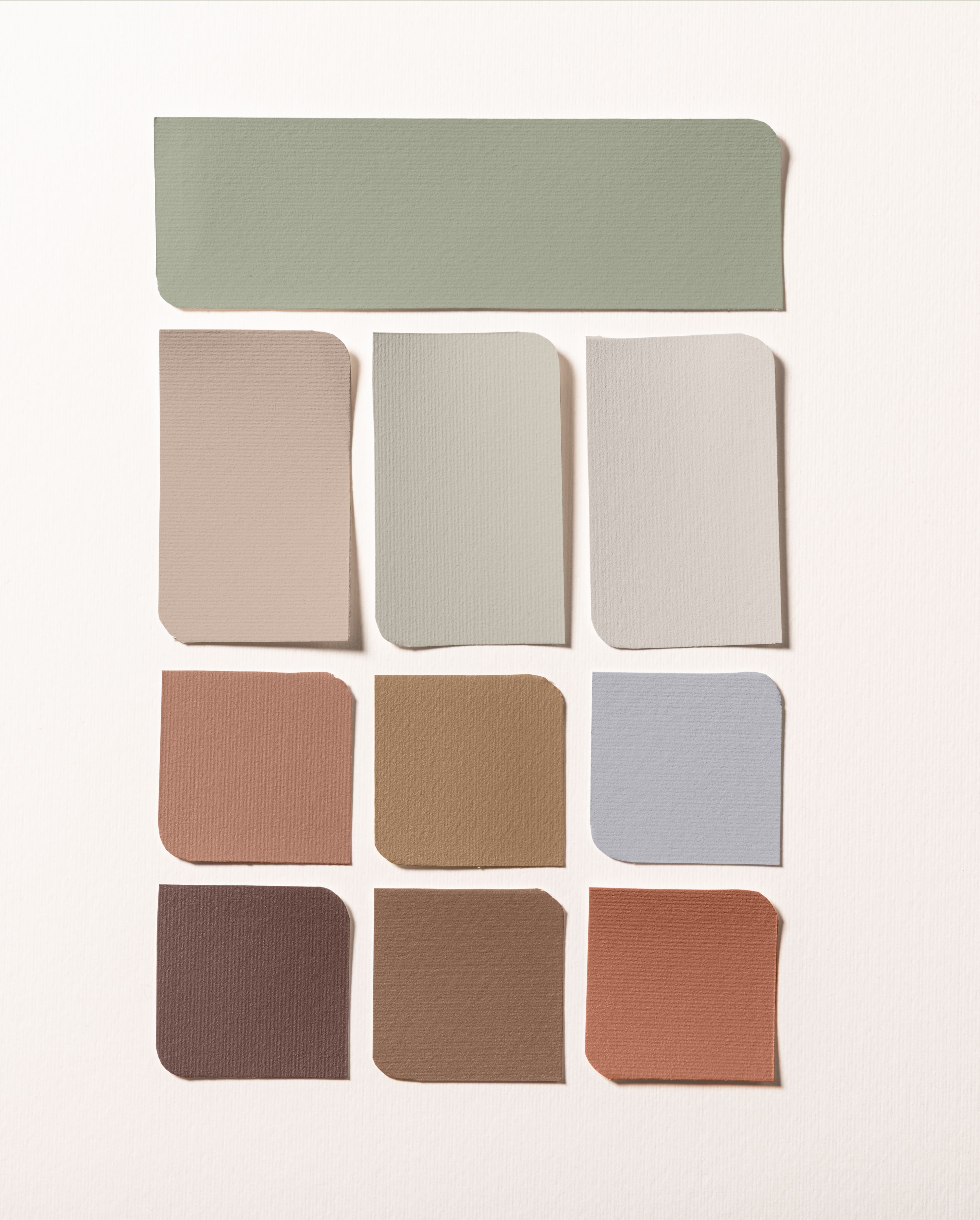 Living room with pale terracotta walls, a pale green cabinet and a colour palette on the right-hand side