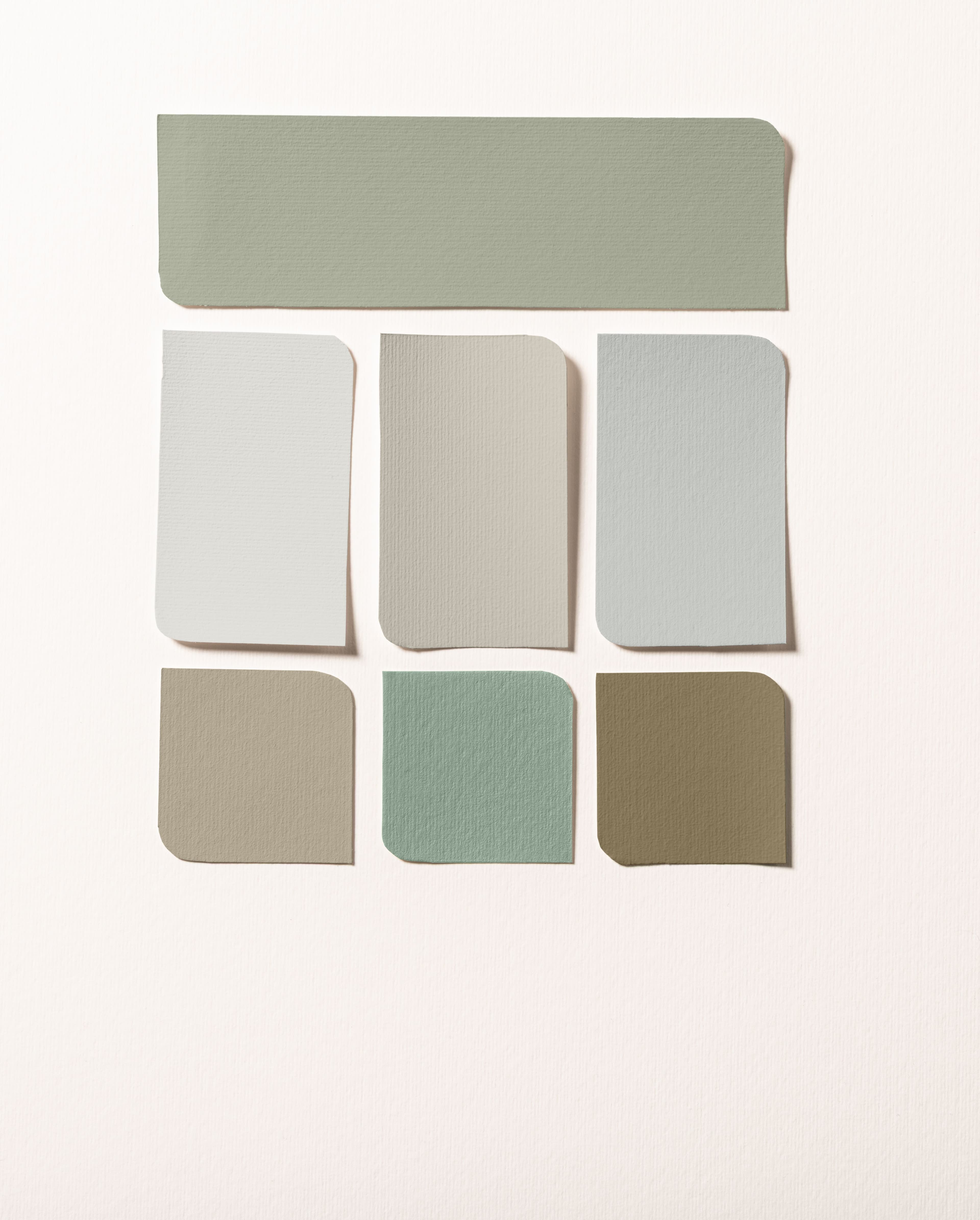 Living room with walls and furniture painted in soft green and a colour palette on the right-hand side