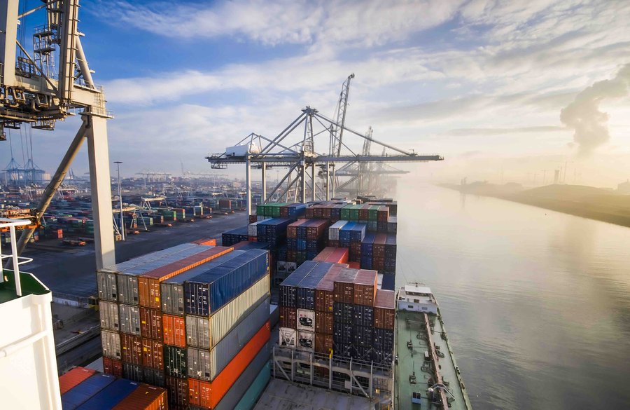 Cargo ship in coastal harbour